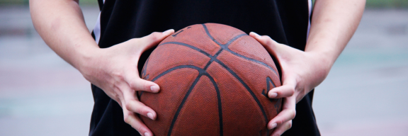 person holding a basketball with both hands in front of them