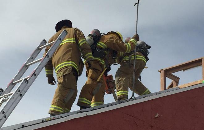Firefighters on roof of building