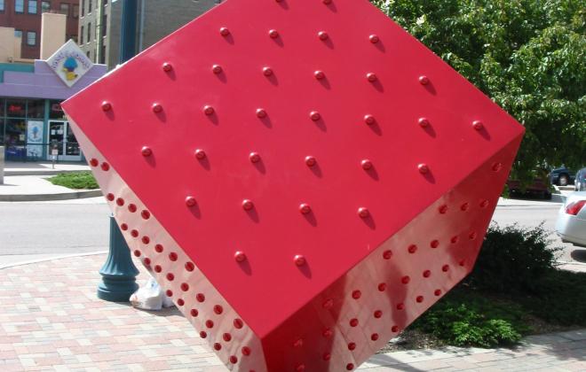 large red cube balancing on one corner