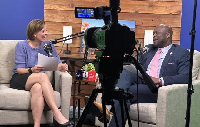 Jen Schreuder laughs in the Behind the Springs studio with Mayor Yemi