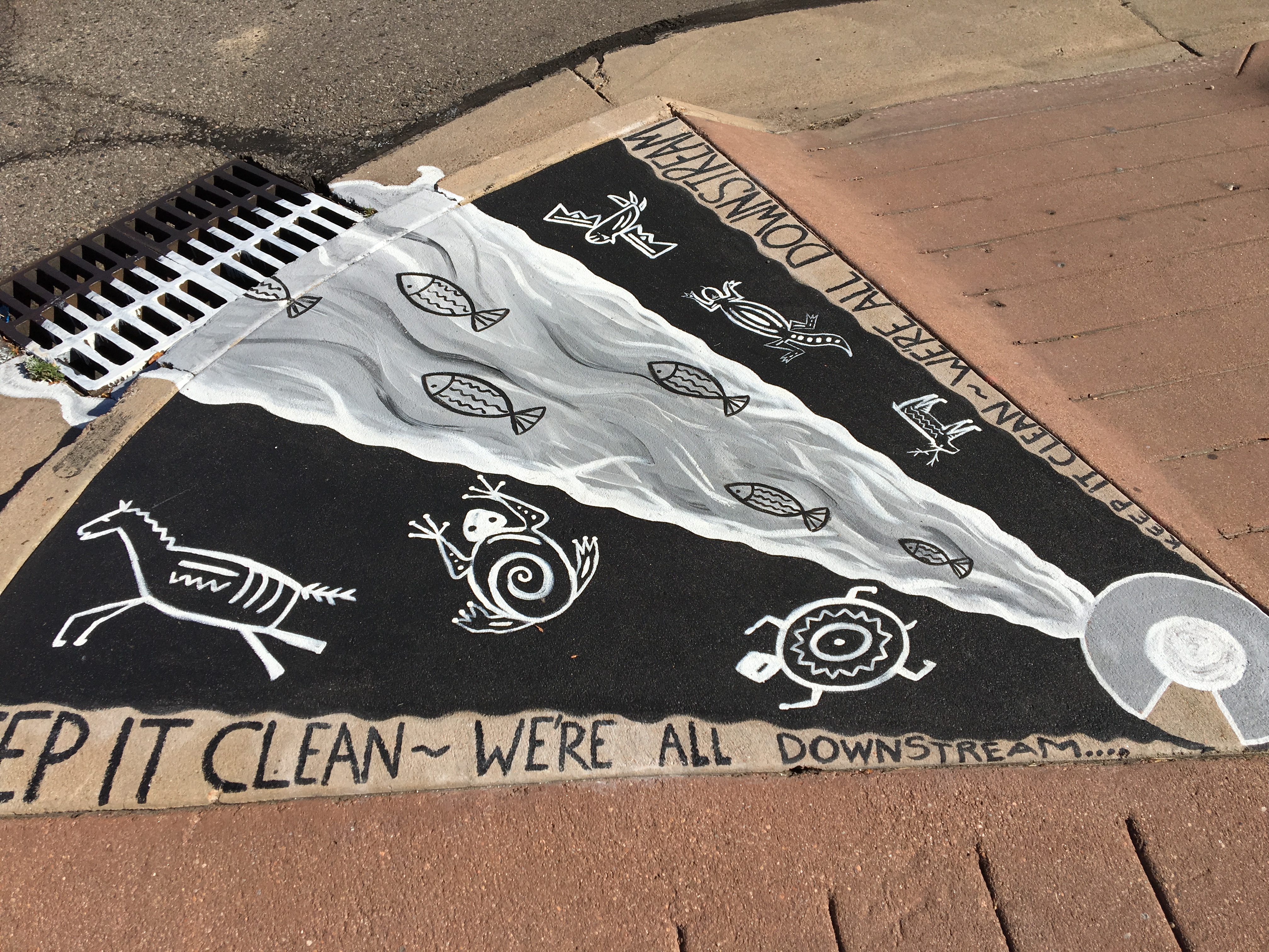 painting showing wildlife and river at end of storm drain. titled "keep it clean, we all live downstream" 
