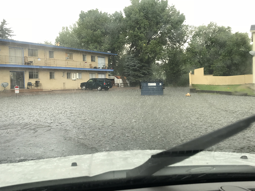 Flood water covers cul-de-sac and goes up to apartment building