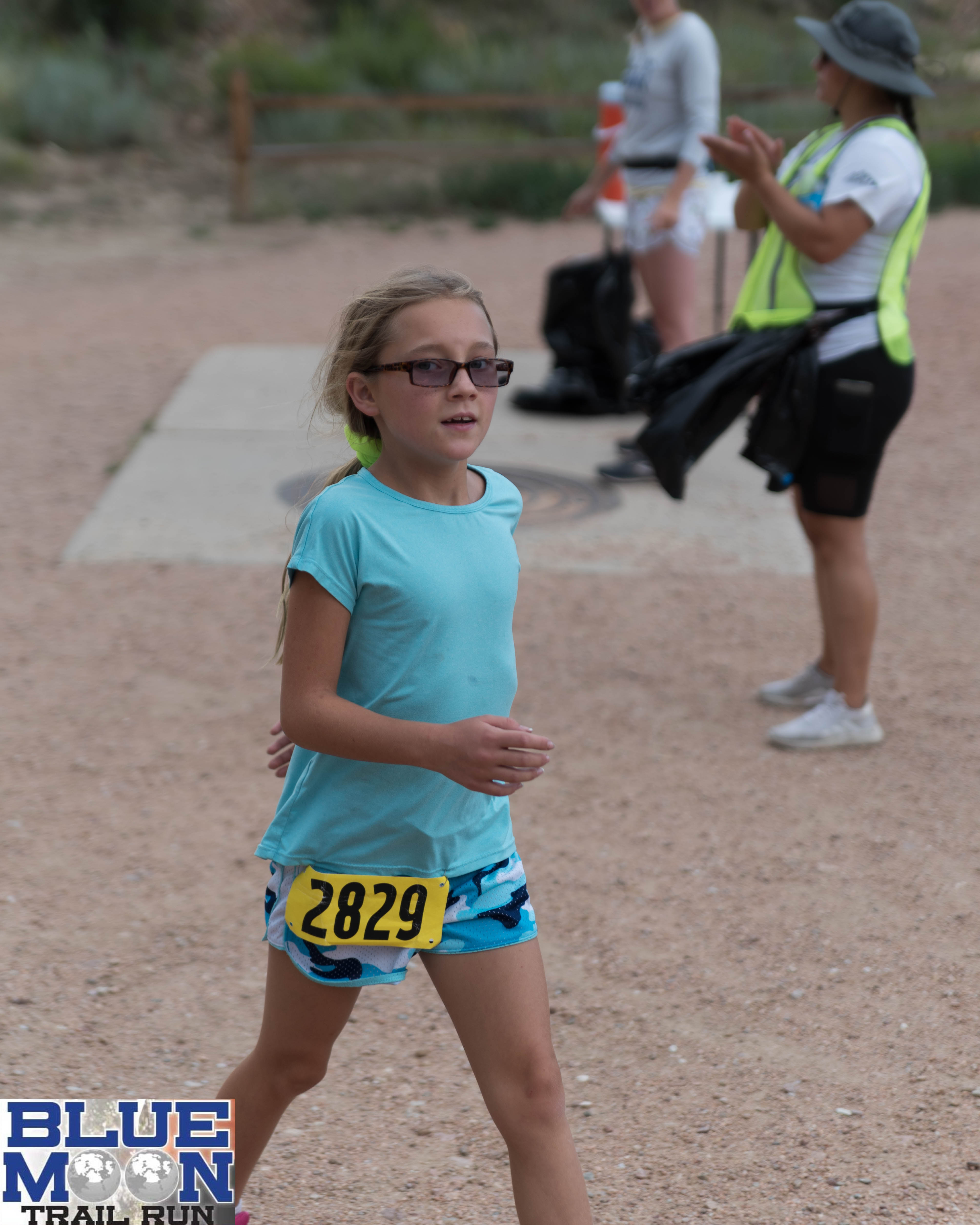 young girl running in Blue Moon 5K