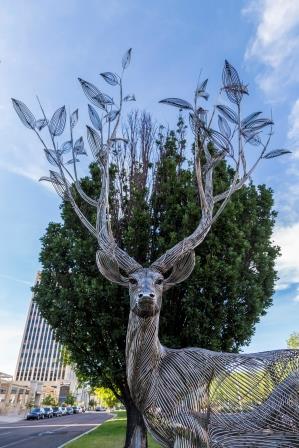 metal-wire deer with tree branches for antlers