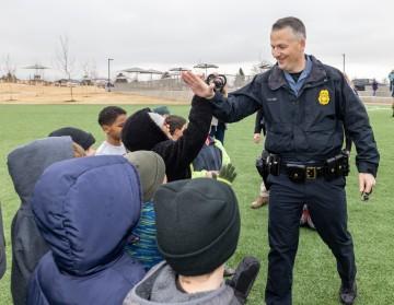 police office high fives kids