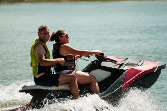 A photo of two people riding on a jet ski on a lake in Colorado Springs.
