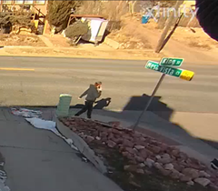 Video surveillance footage portraying: The suspect is described as White or Hispanic, average height and build, with reddish-brown hair in a ponytail, wearing a black sweatshirt, Camouflage-style pants, and “flip-flop” or “slides” shoes.