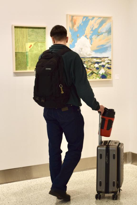 A Colorado Springs Airport passenger looks at the Art at COS gallery.
