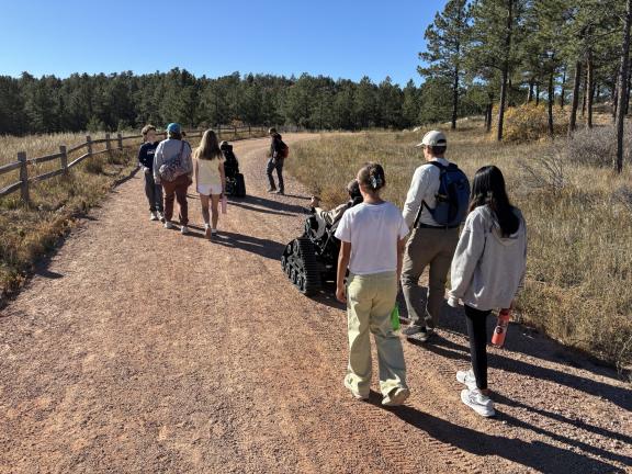 A school group uses a track chair in Ute Valley Park.