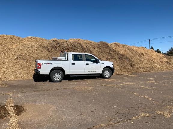 huge pile of mulch larger than a truck
