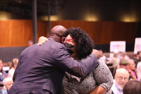 Mayor Yemi hugging a member of the community