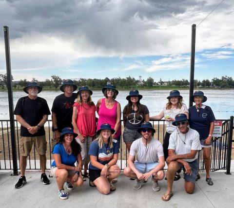 Therapeutic Recreation Program volunteers take a picture together in front of a body of water.