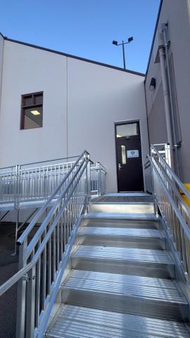 Metal stairs leading up to the entrance of the Global Entry Center