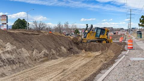 An excavator and the recently leveled dirt north of Astrozon on South Academy Blvd.
