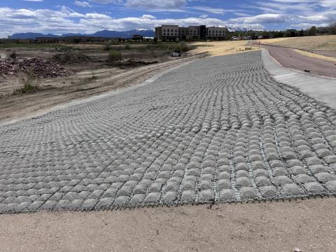 Pictured is a concrete overflow spillway, constructed to the south of the Barnes Water Quality Pond. It is designed to channel any excess water into the Sand Creek pond. This structure prevents water from going into undesired areas surrounding the pond.