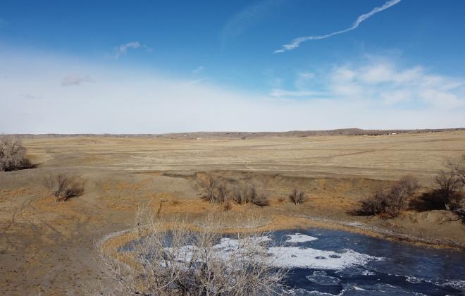 frozen pond, prairie and sky