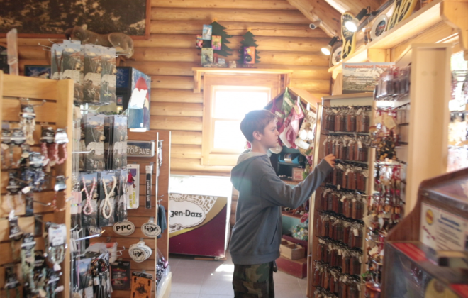 a boy looks at items inside the Crystal Reservoir Gift Shop