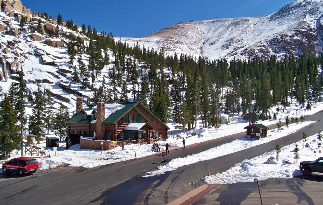 a log cabin gift shop along the snowy Pikes Peak Highway