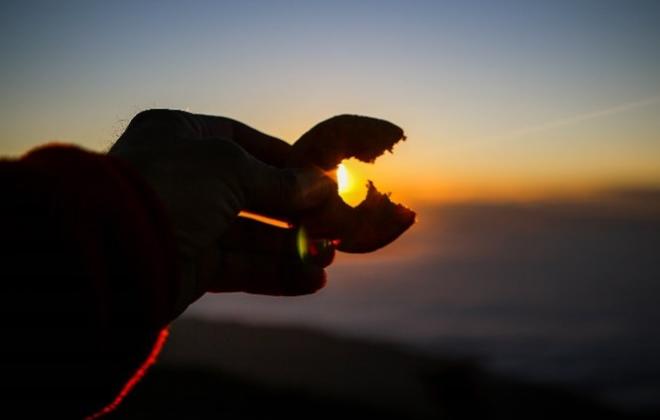 A donut from Pikes Peak in the shape of a 'C' around a sunrise