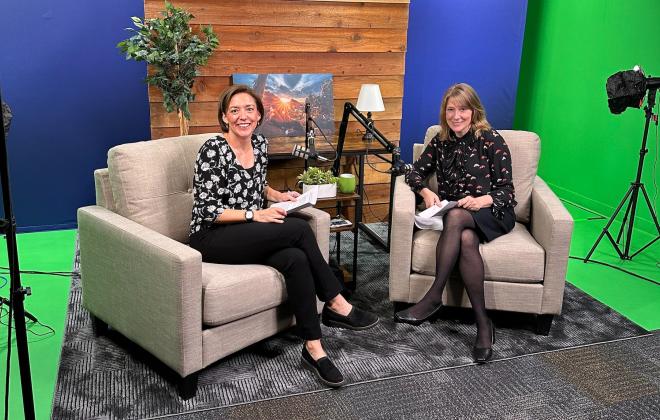 Jen Screuder and Aimee Cox smile for a photo in the Behind the Springs podcast studio.