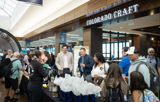 A crowd gathers around the new colorado craft location in the Colorado Springs Airport