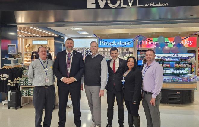 Airport director Alex Kovacs stands with EVOLVE owners