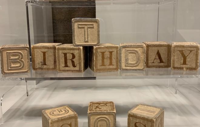 Toy alphabet blocks spell out 'Happy Birthday COS'