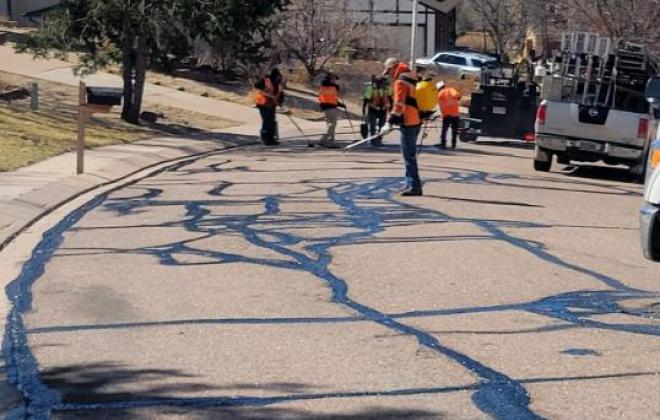 crews apply crack seal to a neighborhood street