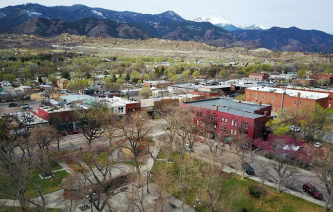 aerial view of Bancroft park and old colorado city with mountains in the background.