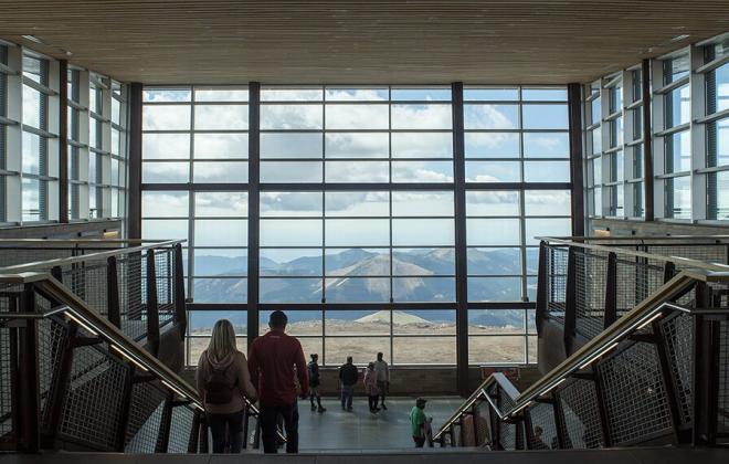 view of the mountains through a large wall of windows in the pikes peak visitor center
