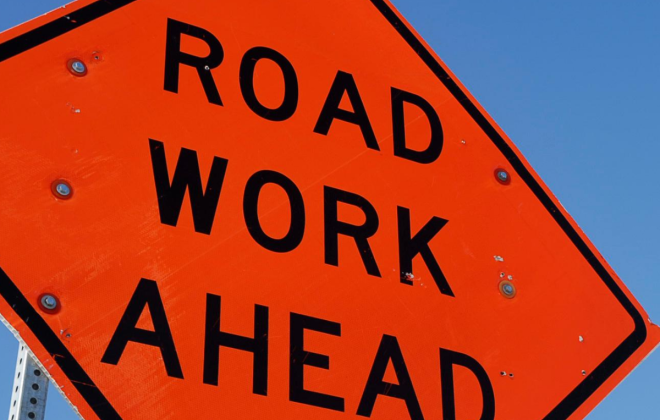orange road work ahead sign