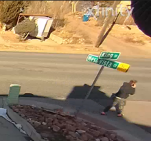 Video surveillance footage depicting: The suspect is described as White or Hispanic, average height and build, with reddish-brown hair in a ponytail, wearing a black sweatshirt, Camouflage-style pants, and “flip-flop” or “slides” shoes.