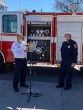 Fire Chief Christian Ontiveros of Nuevo Casas Grandes and Colorado Springs Fire Chief Ted Collas in front of a fire engine
